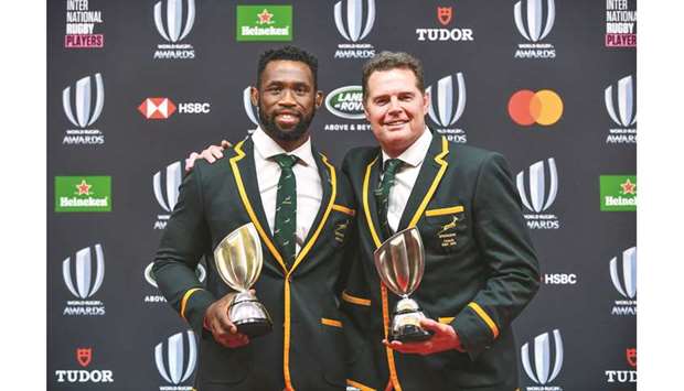 World Rugby Coach of the Year award winner Rassie Erasmus of South Africa (right) and Team of the Year award winner Siya Kolisi of South Africa (left) pose with the trophies following the World Rugby Awards 2019 ceremony in Tokyo yesterday. (AFP)