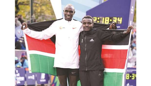 Joyciline Jepkosgei (right) and Geoffrey Kamworor pose after winning the New York City Marathon in New York yesterday. (AFP)