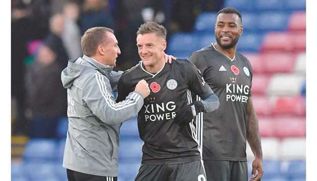 Leicester Cityu2019s Northern Irish manager Brendan Rodgers (left) congratulates Jamie Vardy (centre) as captain Wes Morgan looks on after their win over Crystal Palace in the English Premier League at Selhurst Park in south London yesterday.  (AFP)