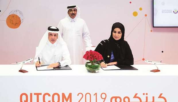 HE the Minister of Transport and Communications Jassim Seif Ahmed al-Sulaiti looks on as HE Akbar al-Baker and Reem al-Mansoori sign the agreement at Qitcom 2019.