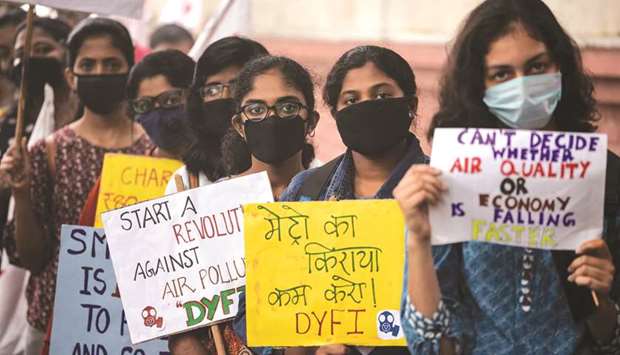 Protesters wearing face masks due to heavy smog conditions take part in a demonstration demanding the government take measures to curb air pollution, in New Delhi yesterday.