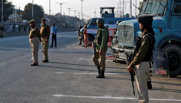 Policemen stand guard on a road in Srinagar. October 31 file picture.