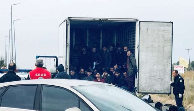 Migrants are seen inside a refrigerated truck found by police, after a check at a motorway near Xanthi