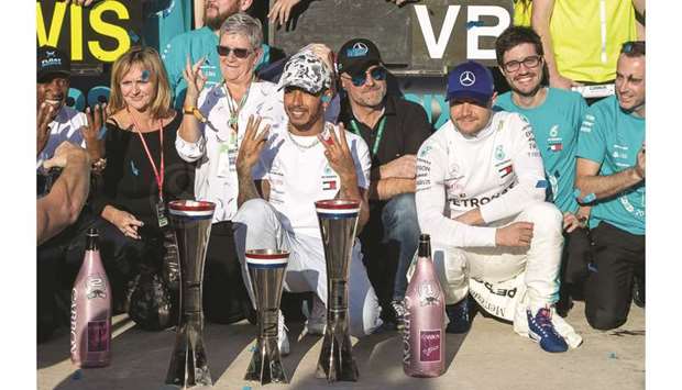 Lewis Hamilton (C) celebrates his sixth F1 world title following the F1 Grand Prix of USA at Circuit of The Americas in Austin, Texas, on Sunday.