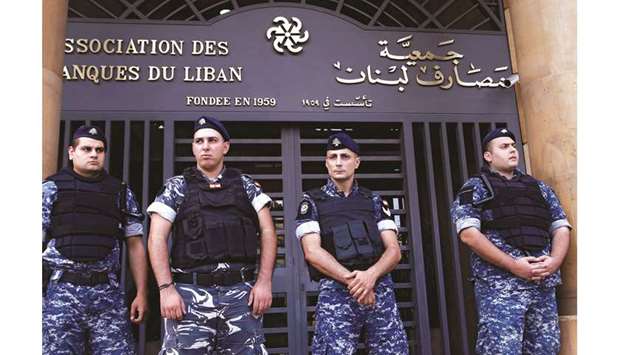 Lebanese police stand outside the entrance to the Association of Banks in downtown Beirut on November 1. The Banque du Liban, as the central bank is known, said in a circular that banks should boost their high-quality capital known as Common Equity Tier 1 through cash injections by 10% by the end of this year and another 10% by June 30, 2020.