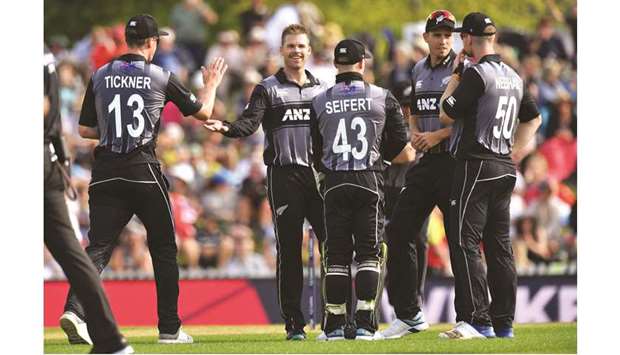 New Zealandu2019s Lockie Ferguson (centre) celebrates with teammates after taking the wicket of Englandu2019s Lewis Gregory (not pictured) during the Twenty20 match in Nelson, New Zealand, yesterday. (AFP)