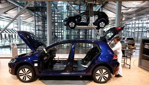 A worker assembles an e-Golf electric car at a production line of German carmaker Volkswagen in Dresden, Germany