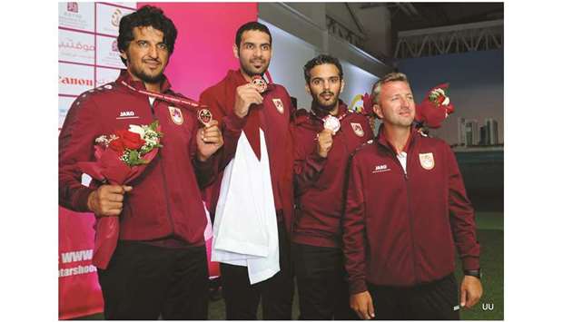 Mohamed al-Rumaihi, Rashid al-Athba, Saeed Abu Sharib and coach Robert Mlodzianowski celebrate with their team bronze  medals at the Lusail Shooting Complex yesterday. PICTURE: Nasar T K