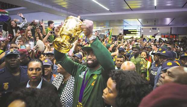 Springboks captain Siya Kolisi holding the World Rugby Cup after his arrival at OR Tambo International Airport in Johannesburg, South Africa, on Tuesday. (AFP)