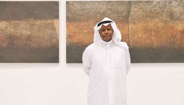 Faraj Daham showcases his works at the exhibition.