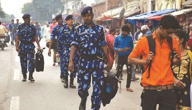Rapid Action Force (RPF) and Uttar Pradesh police personnel patrol a street in Ayodhya yesterday. Authorities have deployed thousands of additional security forces and roped in about 16,000 u201cdigital volunteersu201d to sanitise social media of inflammatory posts ahead of a crucial Supreme Court verdict on the Ayodhya dispute.