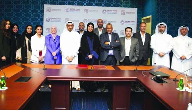 QFFD and Doha Institute for Graduate Studies officials at the agreement signing ceremony.