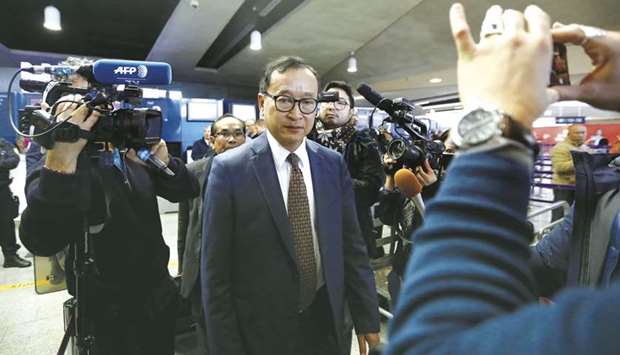 Cambodiau2019s self-exiled opposition party founder Sam Rainsy, who has vowed to return to his home country, leaves after being prevented from checking-in for a flight from Paris to Bangkok at Roissy Airport in Paris, France, yesterday.
