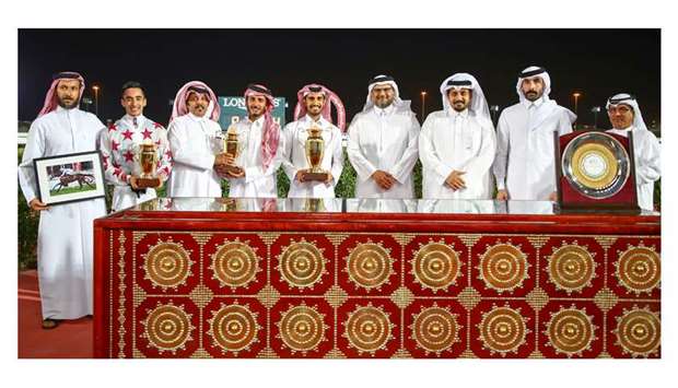 HE Sheikh Saoud bin Abdulrahman bin Hassan al-Abdulrahman al-Thani (fourth from right), QREC CEO Nasser Sherida al-Kaabi (third from right) and QREC Racing manager Abdulla bin Rashid al-Kubaisi (right) with the winners of Al Wukair Cup after Al Lusail won the 1,600m race at the Al Rayyan Park yesterday.