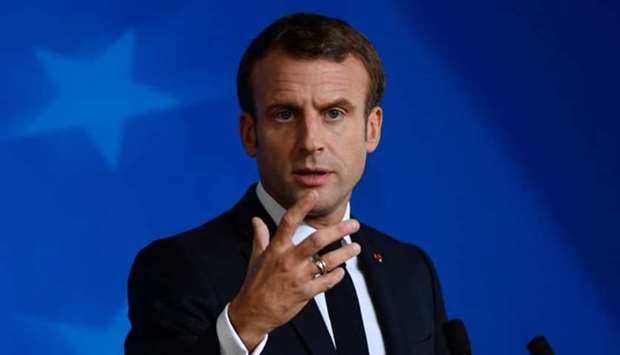 Franceu2019s President Emmanuel Macron gestures as he addresses media representatives at a press conference during a European Union Summit at European Union Headquarters in Brussels on October 18.