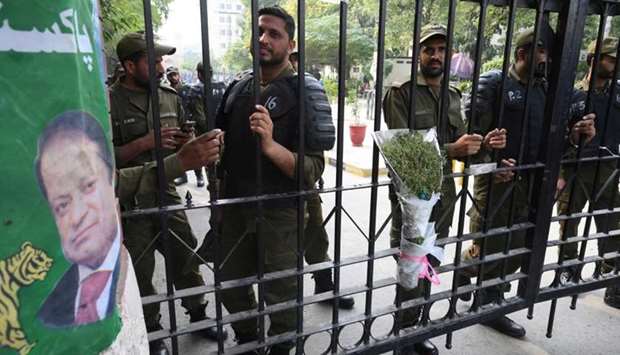 Pakistani policemen stand guard on the gate of a hospital before shifting jailed Pakistan's former prime minister Nawaz Sharif (unseen), in Lahore on November 6, 2019. AFP