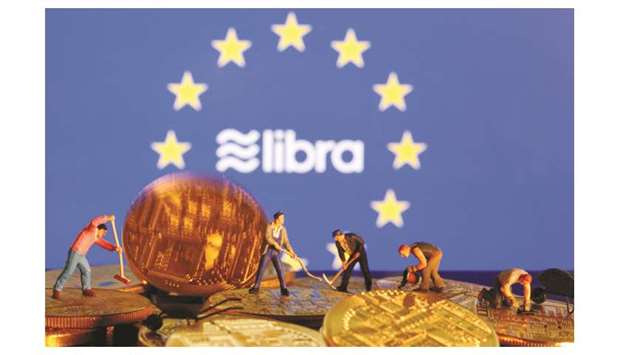 Small toy figures are seen on representations of virtual currency before the European Union flag and the Facebook Libra logo in an illustration. Acknowledging it would take time to develop a European public version of Libra, French Finance Minister Bruno Le Maire told a news conference in Brussels: u201cThe fact that it is for the long term does not prevent us from working and having results next year.u201d