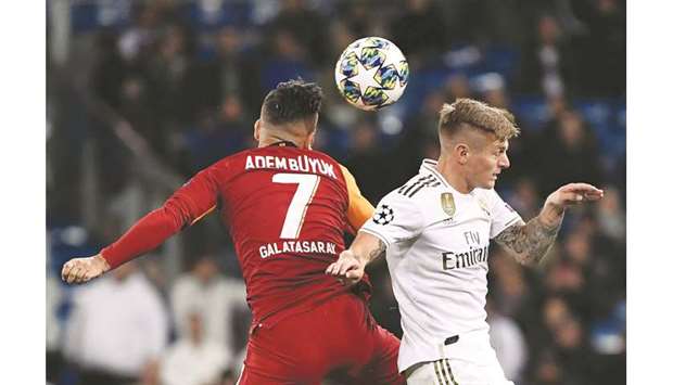 Galatasarayu2019s Turkish midfielder Adem Buyuk (L) and Real Madridu2019s German midfielder Toni Kroos (R) jump for the ball during their UEFA Champions League Group A football match  at the Santiago Bernabeu stadium in Madrid on November 6.