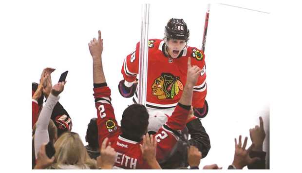 Chicago Blackhawksu2019 Patrick Kane (centre) celebrates after scoring a goal against the Vancouver Canucks during the third period at United Center in Chicago, United States, on Thursday. (USA TODAY Sports)
