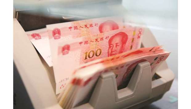 Chinese 100 yuan banknotes are seen in a counting machine at a branch of a commercial bank in Beijing (file). Investors have kept a close watch over Chinau2019s smaller banks after the unexpected government takeover of Baoshang Bank Co in May, which imposed losses on some creditors.