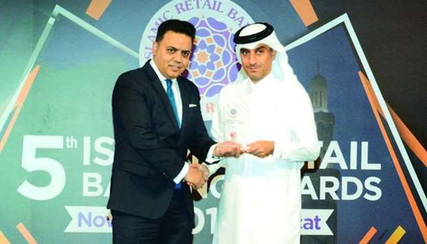 QIIB deputy CEO Jamal Abdullah al-Jamal (right) receiving the awards during a ceremony held in Muscat recently.