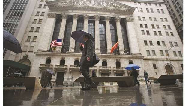Pedestrians walk past the New York Stock Exchange. Beleaguered shares of small US companies are set for a bump in performance as value stocks have risen, market analysts say, but small caps could quickly fade again with an economic setback.