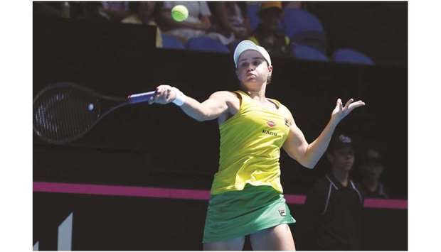 Ashleigh Barty hits a return against Caroline Garcia on day one of the Fed Cup Final in Perth yesterday. (AFP)