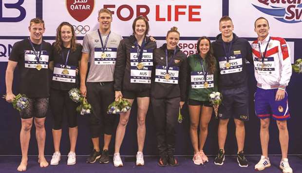 Swimmers pose with their medals on the final day of the FINA Swimming World Cup at the Hamad Aquatic Centre yesterday.