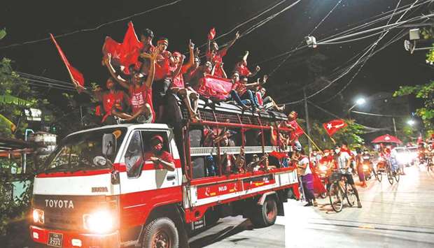 Supporters of the National League for Democracy (NLD) party celebrate in Yangon yesterday as NLD officials said they were confident of a landslide victory in the weekendu2019s election.
