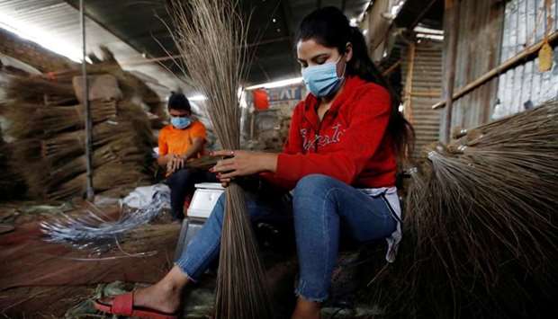 Workers make brooms at a workshop ahead of the Tihar festival, also known as Diwali, amid the spread of Covid-19 in Kathmandu, Nepal on November 6.