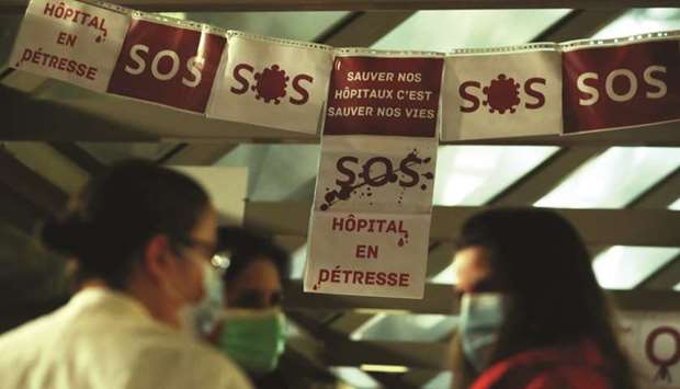 Health workers attend a 24-hour protest at the Erasme hospital in Brussels, to urge the government to increase staff as hospitals fill once again with patients suffering from the coronavirus disease. The signs read u2018Hospital in distressu2019 and u2018To save our hospitals is to save our livesu2019.