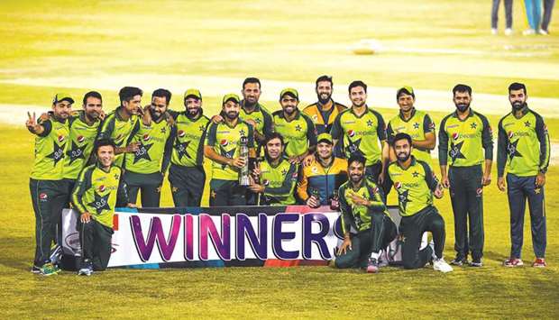Pakistan players pose with the trophy after winning the Twenty20 series against Zimbabwe in Rawalpindi yesterday. (AFP)