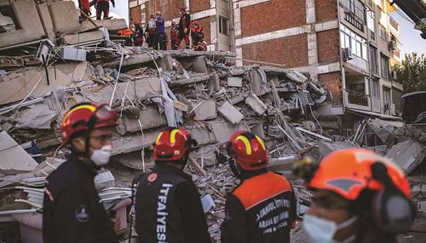Volunteers and rescue personnel search for survivors in a collapsed building in Izmir yesterday after a powerful earthquake struck Turkeyu2019s western coast and parts of Greece.