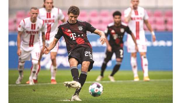 Bayern Munichu2019s German forward Thomas Mueller scores during the Bundesliga match against Cologne yesterday. (AFP)