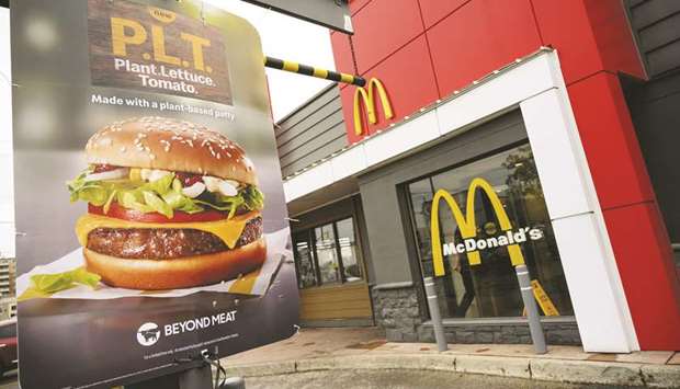This picture taken on October 2 last year shows a sign promoting McDonaldu2019s u2018PLTu2019 burger with a Beyond Meat plant-based patty at one of 28 test restaurant locations in Ontario, Canada.