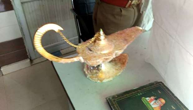 The lamp which was allegedly sold for $93,000 with the claim that it had magic powers as described in the popular folk tale ,Aladdin's lamp,, at the Brahampuri police station in New Delhi.AFP/Uttar Pradesh Police