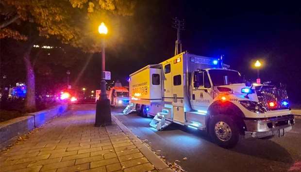 A Police truck is parked near the National Assembly of Quebec, in Quebec City, early Sunday, after two people were killed and five wounded by a sword-wielding suspect dressed in medieval clothing.