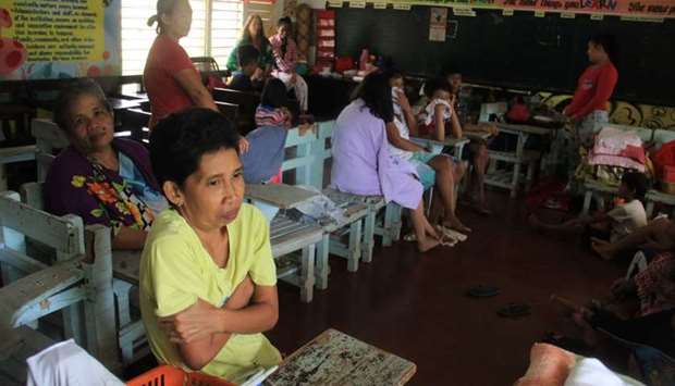 Residents shelter in a classroom used as an evacuation centre in Camalig town, Albay province, ahead of the landfall of Tropical Storm Vamco -- expected to intensify into a typhoon.