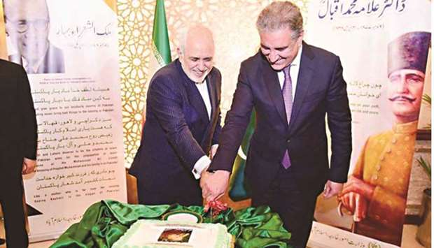 Foreign Minister Shah Mehmood Qureshi (right) and his Iranian counterpart Javad Zarif cutting a cake to mark the 143rd birth anniversary of Pakistanu2019s national poet Dr Sir Allama Muhammad Iqbal, which fell on November 9, in Islamabad yesterday. Iqbal, whose verses had a considerable Persian influence, is revered in both the countries.