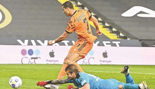 Juventusu2019 Cristiano Ronaldo scores past Speziau2019s goalkeeper Ivan Provedel during the Serie A match in Cesena, Italy, yesterday. (AFP)