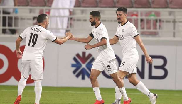Al Sadd captain Hassan al-Haydos (centre) celebrates with Santi Cazorla (left) and Baghdad Bounedjah after their victory over Al Duhail in the semi-finals of the Amir Cup at the Abdullah bin Khalifa Stadium on Saturday.