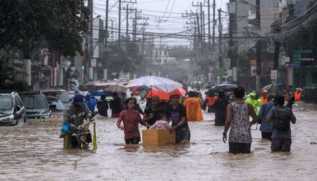 Residents evacuate from their flooded communities as Typhoon Vamco batters the Philippine capital, in Marikina, Metro Manila, Philippines