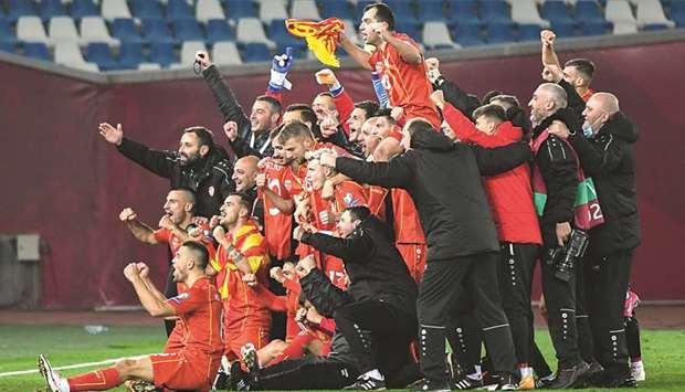 North Macedoniau2019s players and staff celebrate after their 1-0 win against Georgia in the Euro 2020 qualifying play-off final. (AFP)