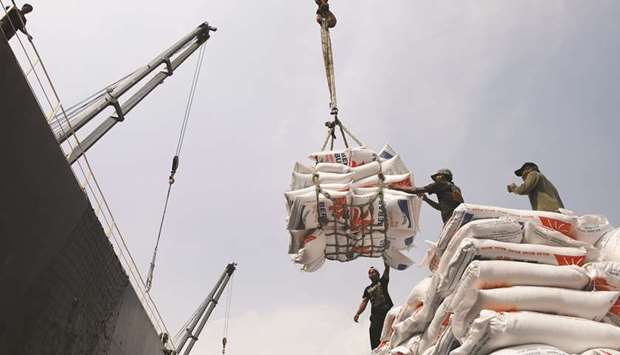 Workers unload bags of rice from a cargo ship onto a truck at Tanjung Priok Port in Jakarta (file). An Asia-Pacific trade deal backed by China could hurt small scale farmers, cause more land conflicts, and leave workers in poorer nations without protection as they struggle to deal with the Covid-19 pandemic, human rights groups said on Friday.