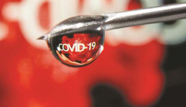 The word u201cCovid-19u201d is reflected in a drop on a syringe needle in this illustration taken on November 9. G20 countries have agreed for the first time on a common framework for restructuring government debt, in anticipation of the coronavirus crisis leaving some poorer nations struggling to pay and in need of relief.