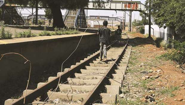 People pull a cable at the vandalised train station in Sowetou2019s Kliptown.