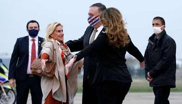 Secretary of State Mike Pompeo, center, and his wife Susan (L) embrace US Ambassador to France Jamie McCourt (L) after stepping off a plane at Paris Le Bourget Airport