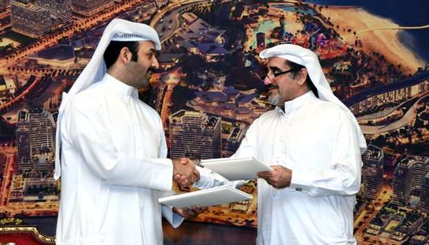 Qetaifan Projects managing director Sheikh Nasser bin Abdul Rahman al-Thani shaking hands with Al Boraq Automobiles chairman and CEO Salman Jassim al-Darwish after signing an MoU on the sidelines of a recent launch event. PICTURE: Ram Chand.