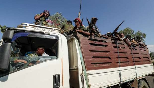 Members of Amhara region militias ride on their truck as they head to face the Tigray People's Liberation Front (TPLF), in Sanja, Amhara region near a border with Tigray, Ethiopia