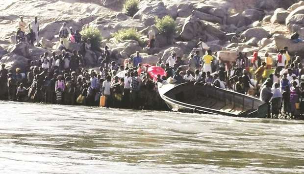 Ethiopians who fled the ongoing fighting in Tigray region prepare to cross the Setit River on the Sudan-Ethiopia border, near Hamdait village in Sudanu2019s eastern Kassala state.